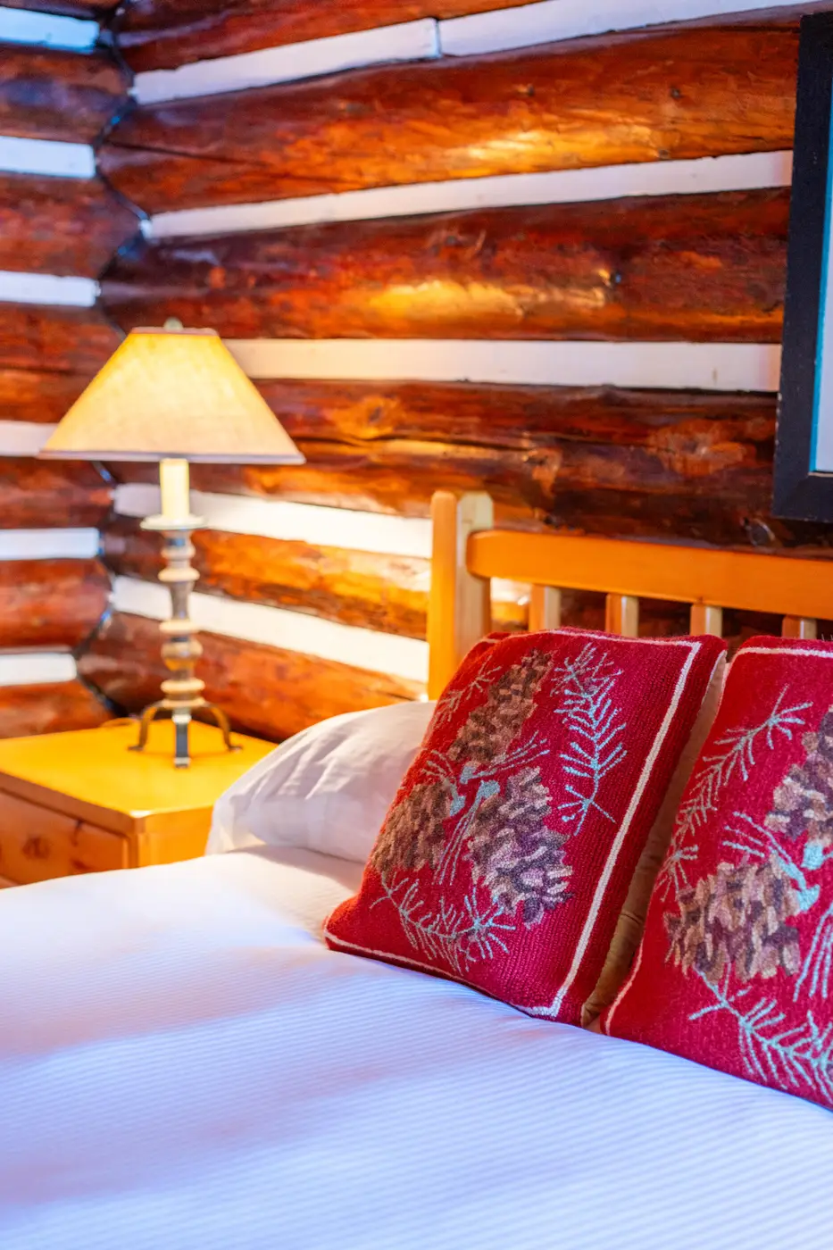 Hand sown pillows in a rustic cabin bedroom.