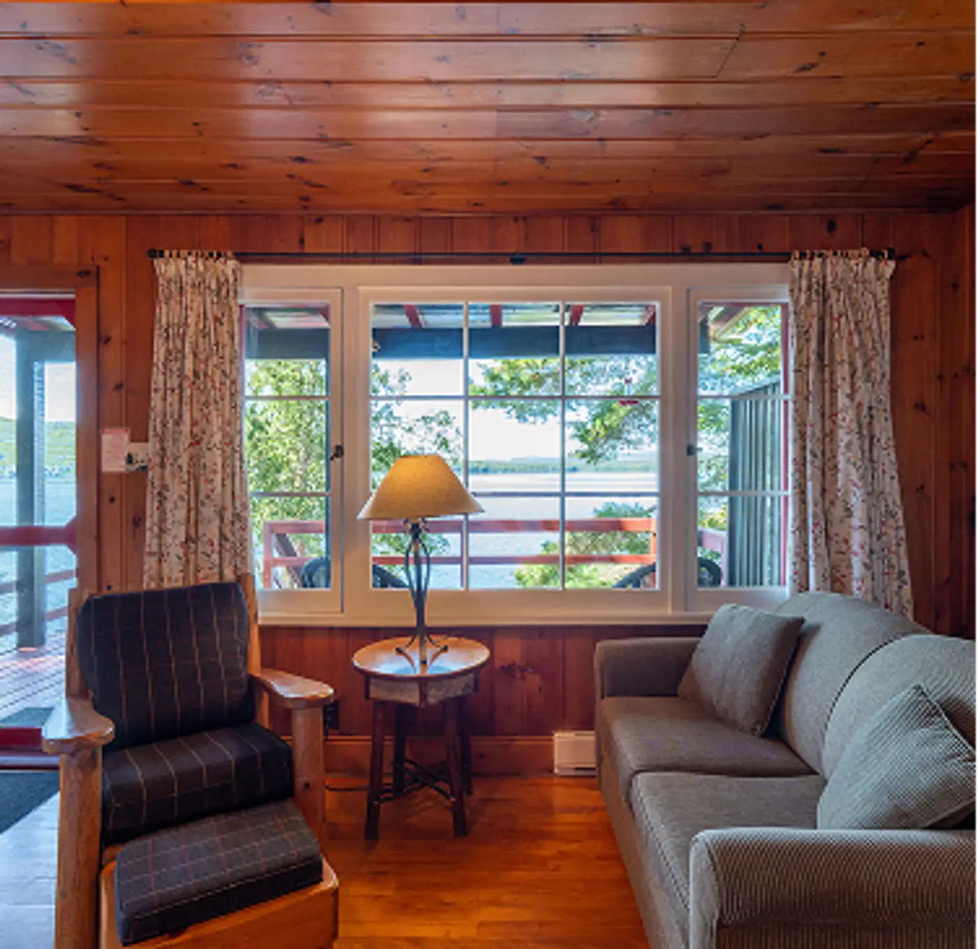 Cabin living room with couch and comfortable recliners at Killarney Lodge in Algonquin Park.