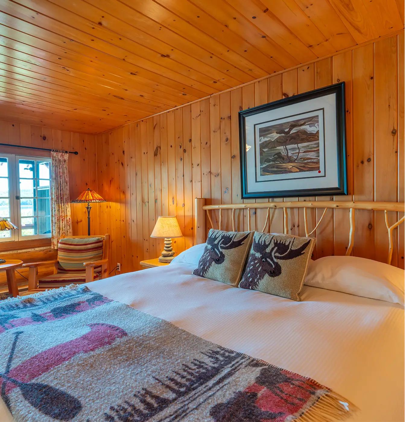 Cabin interior with fresh linens, and handmade furnishings at Killarney Lodge in Algonquin Park.