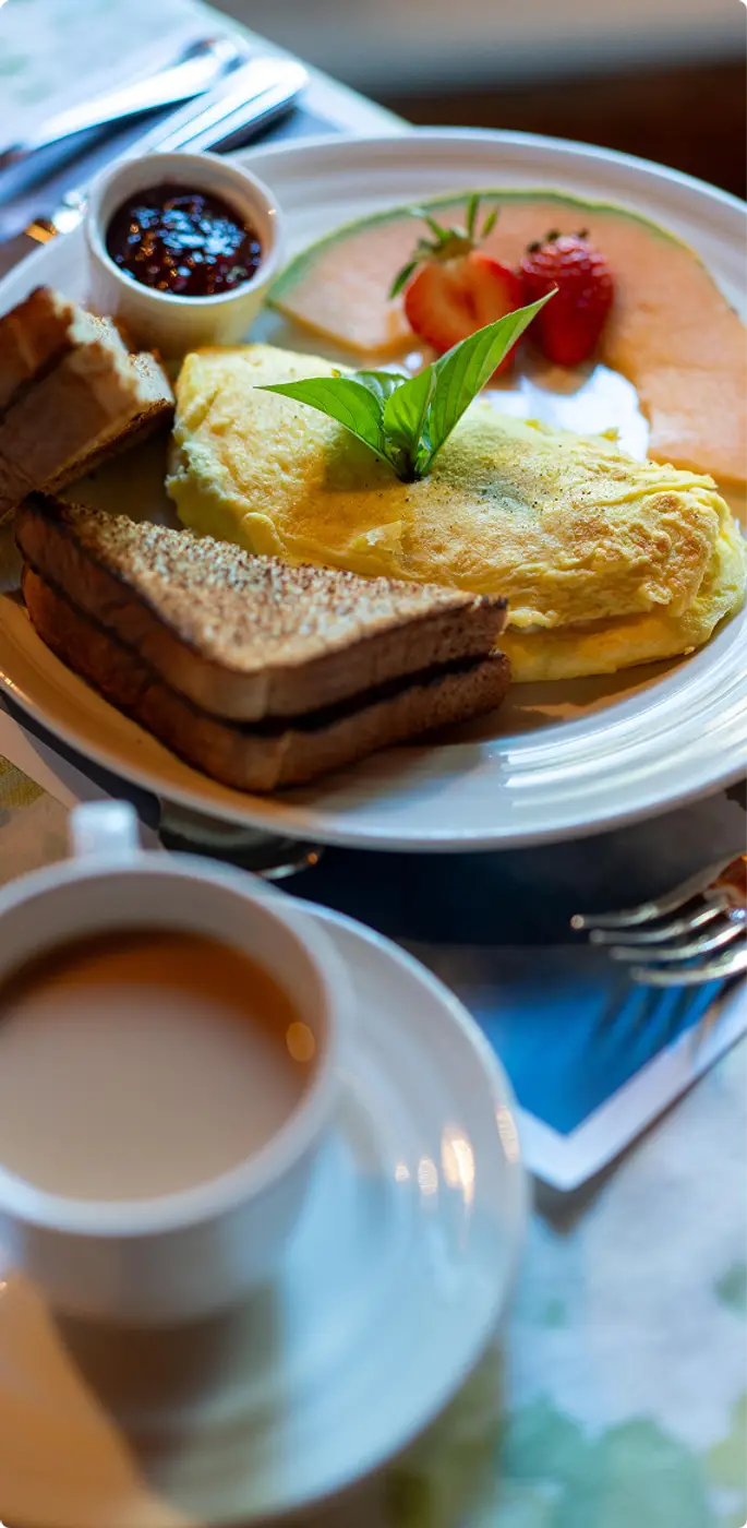 A delicious breakfast with toast, fruit, freshly prepared omelet with coffee at Killarney Lodge in Algonquin Park.