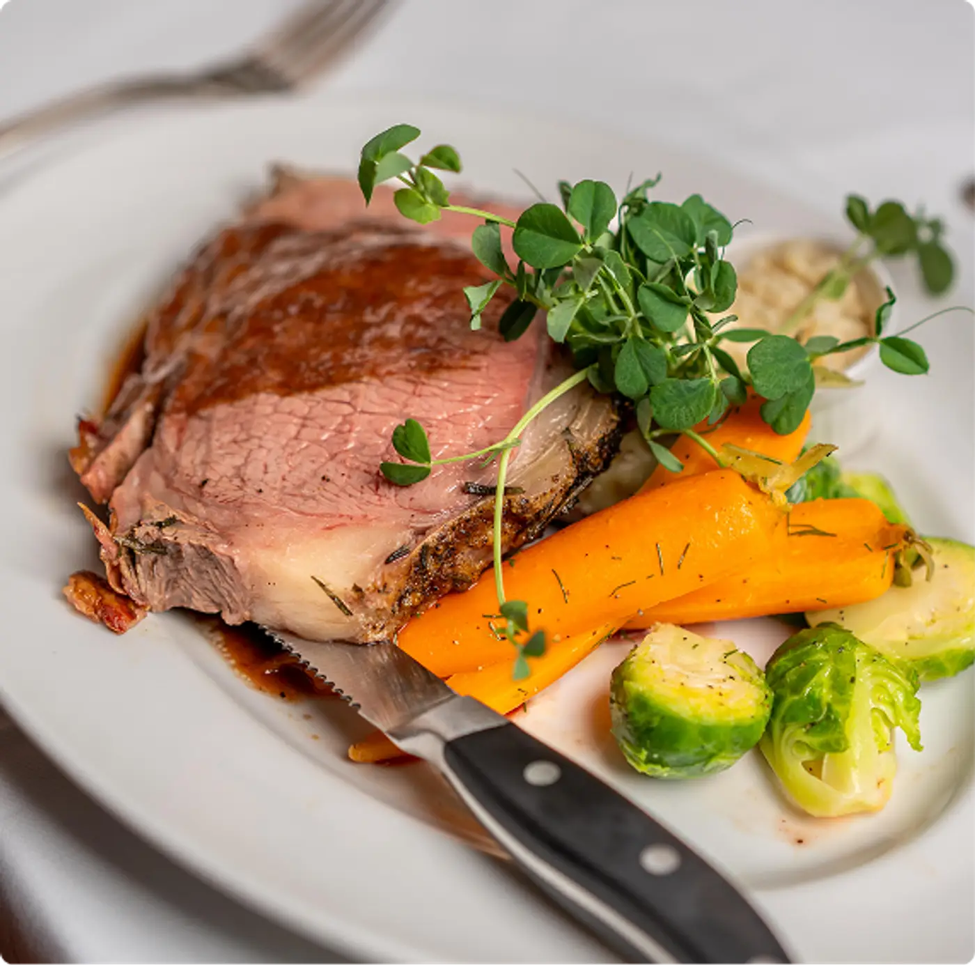 Prime rib or beef served with vegetables and fresh garnish at Killarney Lodge in Algonquin Park.