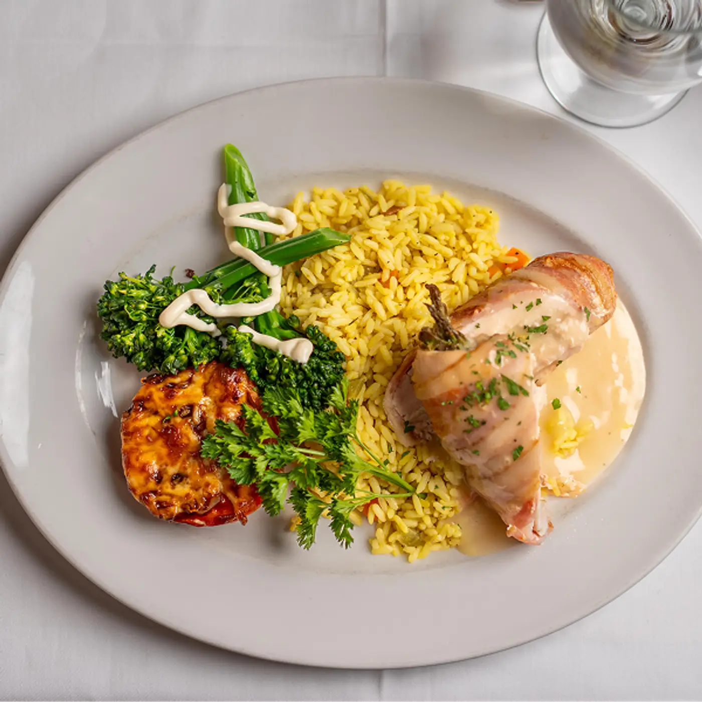 Seared Atlantic Salmon topped with fresh herb sauce served with rice and Chef’s daily vegetables at Killarney Lodge in Algonquin Park.