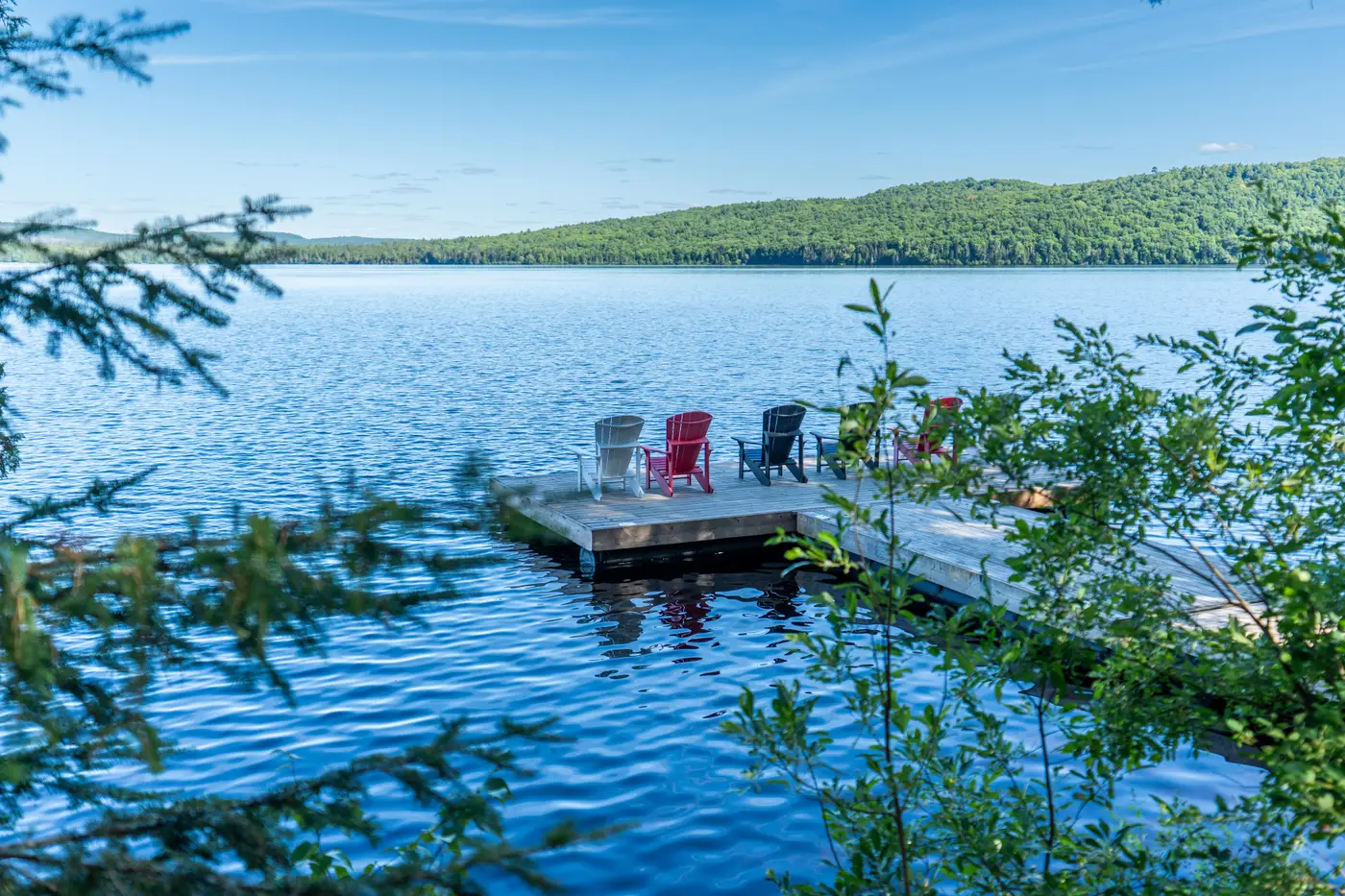 View of our walk-out dock featuring reclining chars facing the Lake of Two Rivers at Killarney Lodge in Algonquin Park.